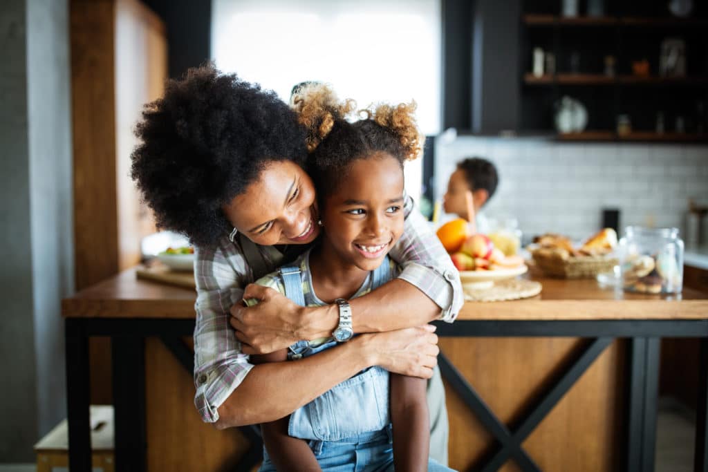 Happy mother and children in the kitchen. Healthy food, family, cooking concept