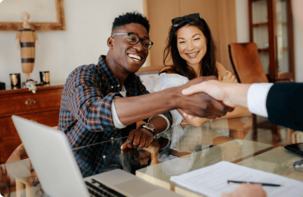 Young couple shaking hands with loan officer