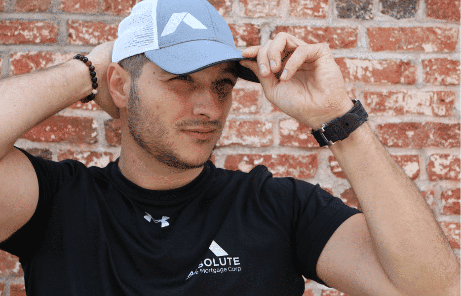 Young man wearing Absolute Home Mortgage t-shirt and hat